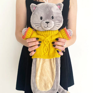 Person holding the House of Disaster Cat Hot Water Bottle to show its size.