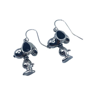 Angled view of Snoopy earrings, showcasing their 3D design and silver-tone finish.