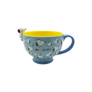 A side view of the Snoopy ‘Be Happy’ Cup against a plain white background, showing its yellow interior, blue base, and charming Peanuts-themed design.