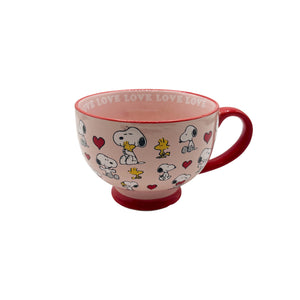 A side view of the Peanuts Love Mug, highlighting its pink exterior, red handle, and adorable Snoopy and Woodstock design.