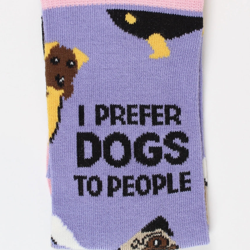 Front of folded bamboo sock featuring bold “I Prefer Dogs to People” slogan with dog motifs on a lilac background and pink cuff.