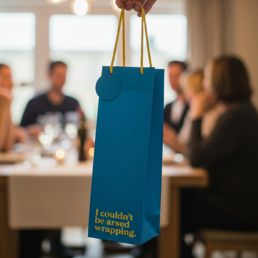 Blue bottle gift bag held at dinner party setting