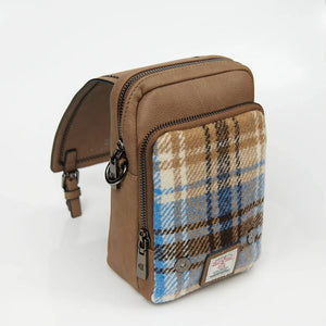 The interior of a blue and beige Harris Tweed bag, revealing its spacious compartment.