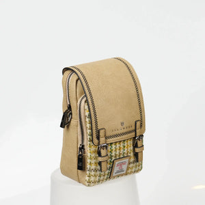 A yellow dogtooth Harris Tweed bag, photographed from the side.