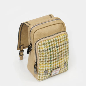 A yellow dogtooth Harris Tweed bag with the top flap open, revealing the interior.