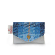 Front view of Islander Blue Tartan Harris Tweed Card Holder featuring a soft blue base, envelope-style flap, metal crest detail, and Harris Tweed certification tag.
