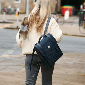 A navy over-check Islander Carloway backpack worn by a blonde woman.