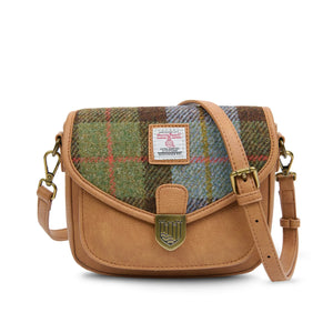 Ladies Harris Tweed Mini Saddle Bag finished with a Chestnut Brown & Blue Tartan fabric. The shoulder strap is draped over the top.