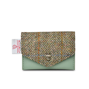 Front view of Islander Chestnut Herringbone Harris Tweed Card Holder with green leather base, classic tweed flap, metal crest, and official Harris Tweed tag.