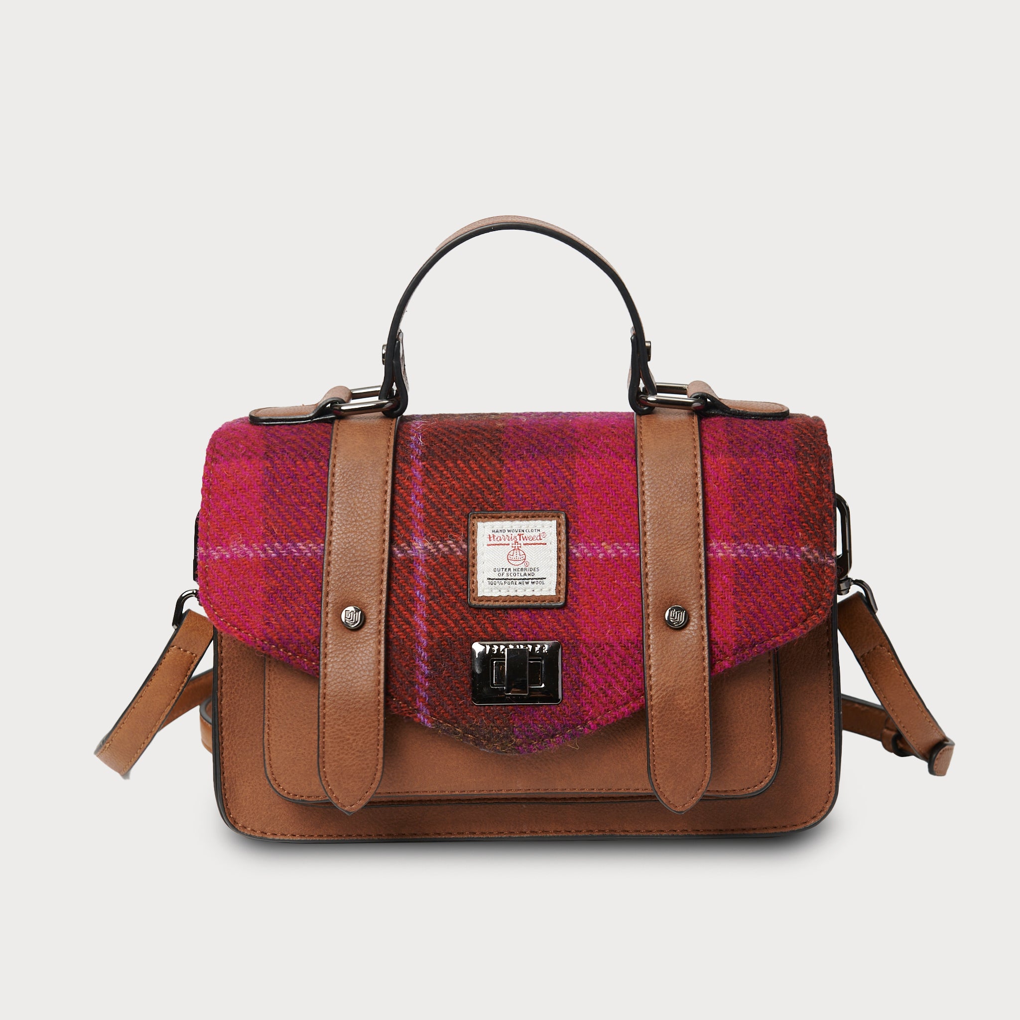 Front view of Fuchsia Red Tartan Harris Tweed® satchel with detachable strap and silver clasp detail.