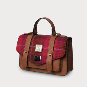 Side angle of Fuchsia Red Tartan Harris Tweed® satchel showing structured shape and top handle.