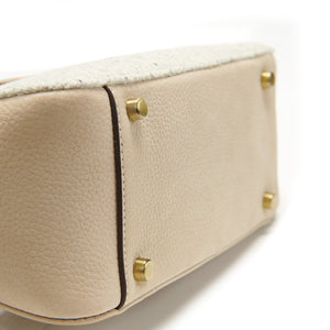 View of the sturdy gold base studs on the Islander Caithness Harris Tweed Clutch Bag in cream.