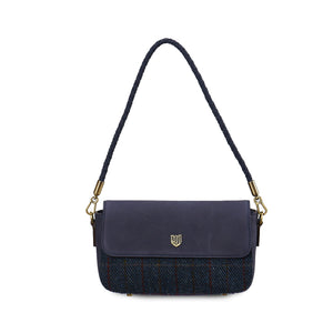 Front view of the Islander Caithness Harris Tweed Clutch Bag in navy over-check tartan with an adjustable navy leather strap.