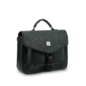 A side-angle view of a black herringbone Harris Tweed laptop case, showcasing its shape and design.
