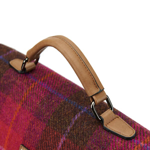 A close-up of the top handle on a red tartan Harris Tweed laptop case.