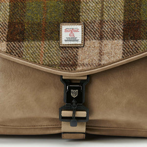 A close-up of the front of the Islander Harris Tweed laptop case in chestnut tartan, showcasing its unique design and metal hardware.