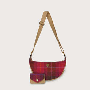 A red tartan Harris Tweed Luna bag with a matching purse sitting in front of it, on a white background.