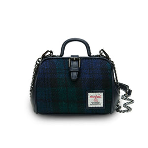 A stylish mini doctor bag crafted from sophisticated Black Watch Tartan Harris Tweed, featuring two top handles and a detachable shoulder strap hanging by the side. (Islander)