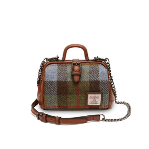 A stylish mini doctor bag crafted from a unique chestnut and blue tartan Harris Tweed, featuring two top handles and a detachable shoulder strap resting in front of the bag. (Islander)