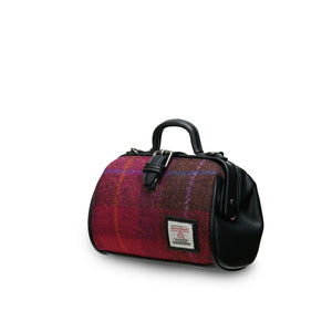 A side view of a classic mini doctor bag crafted from a bold red tartan Harris Tweed. The image showcases its two top handles and compact size. (Islander) 