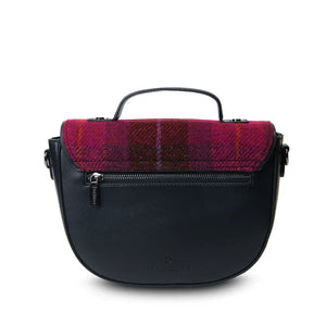 A rear view of a red tartan Harris Tweed Cobble Satchel, displaying its additional pocket and shoulder strap.