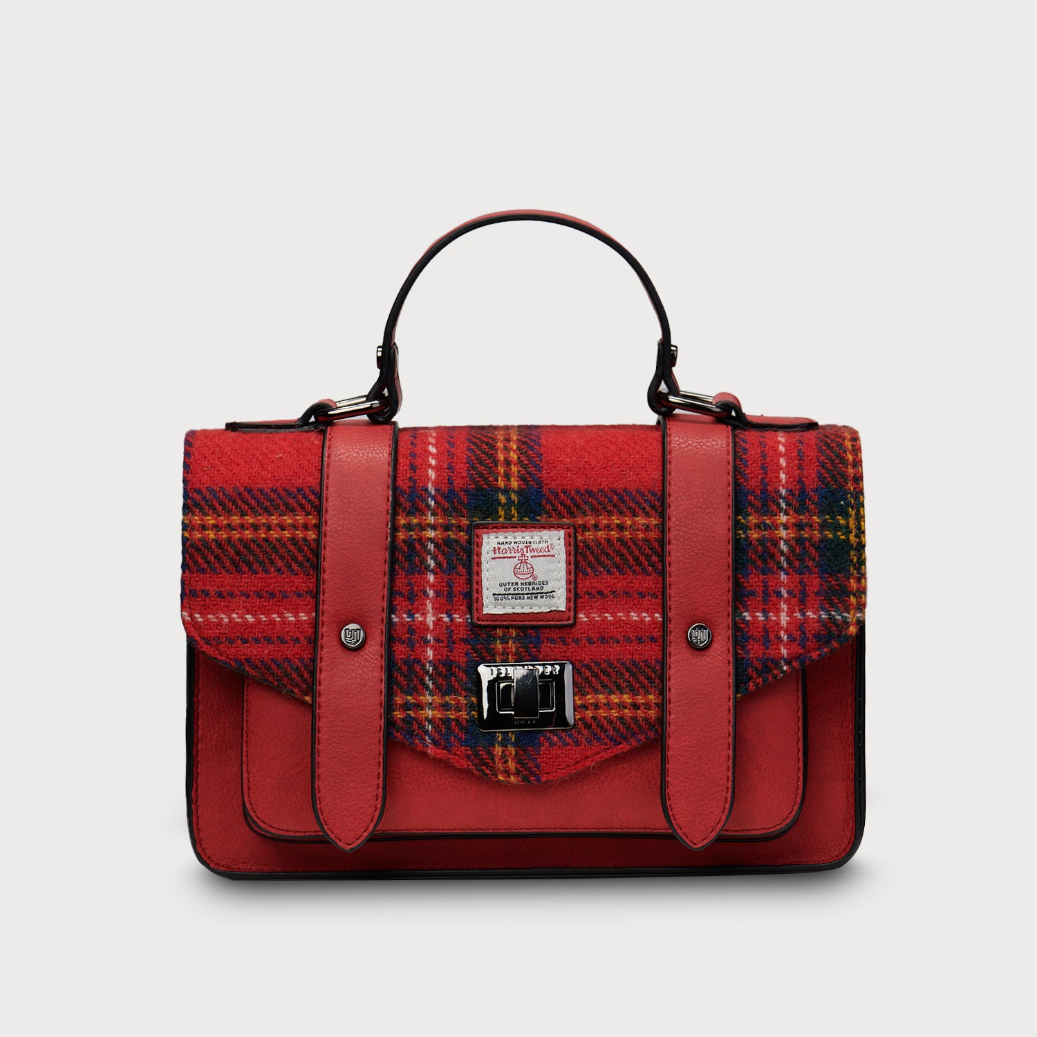 Front-facing image of Islander Harris Tweed Satchel in Royal Stewart Tartan with bold red leather trim and Harris Tweed certification label.