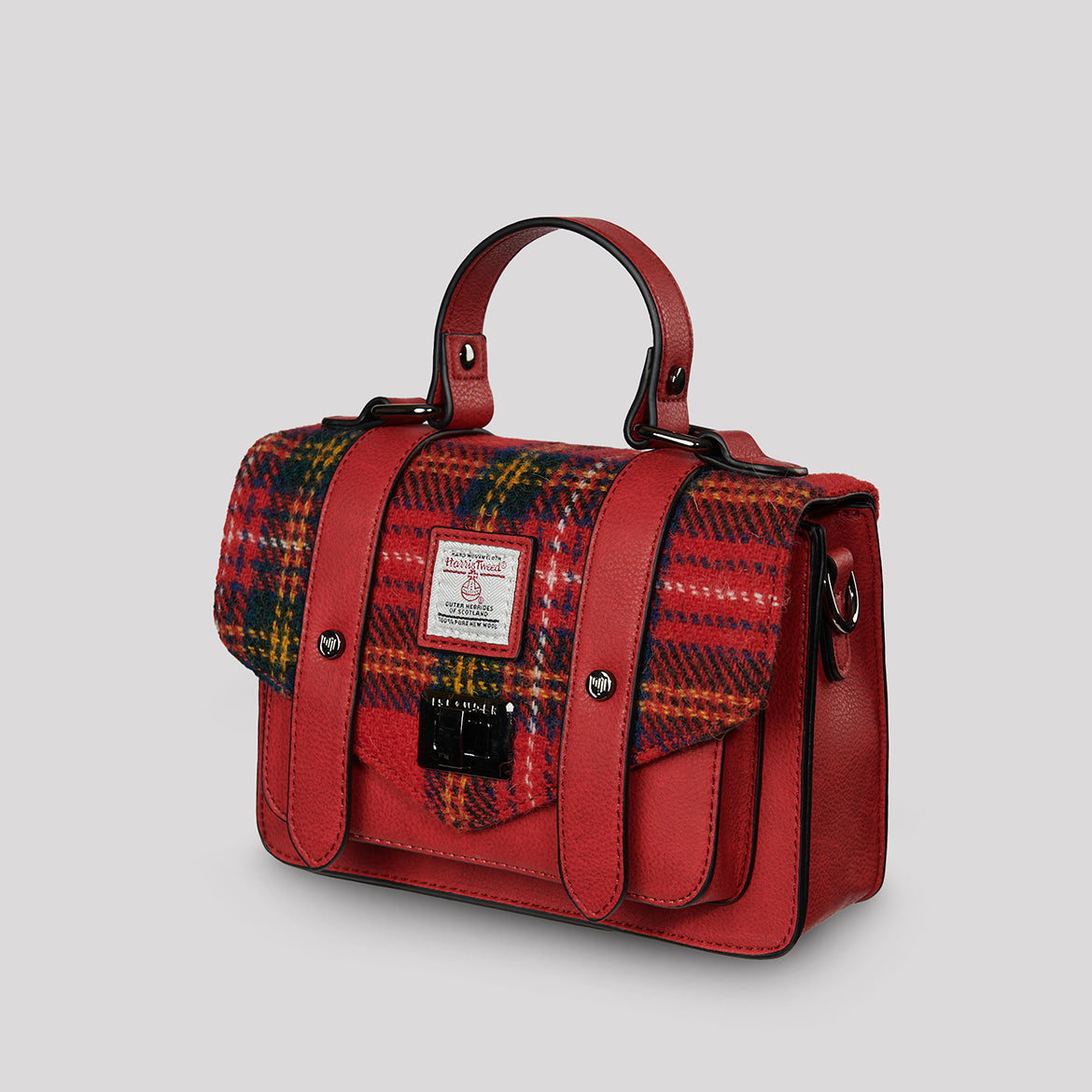 Side angle view of the Royal Stewart Tartan satchel showing structured silhouette, top handle, and crossbody strap.