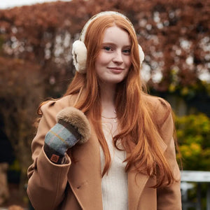 A woman wearing Islander Ladies Lambswool Mittens in Chestnut and Blue Tartan, showcasing the cozy and stylish design.