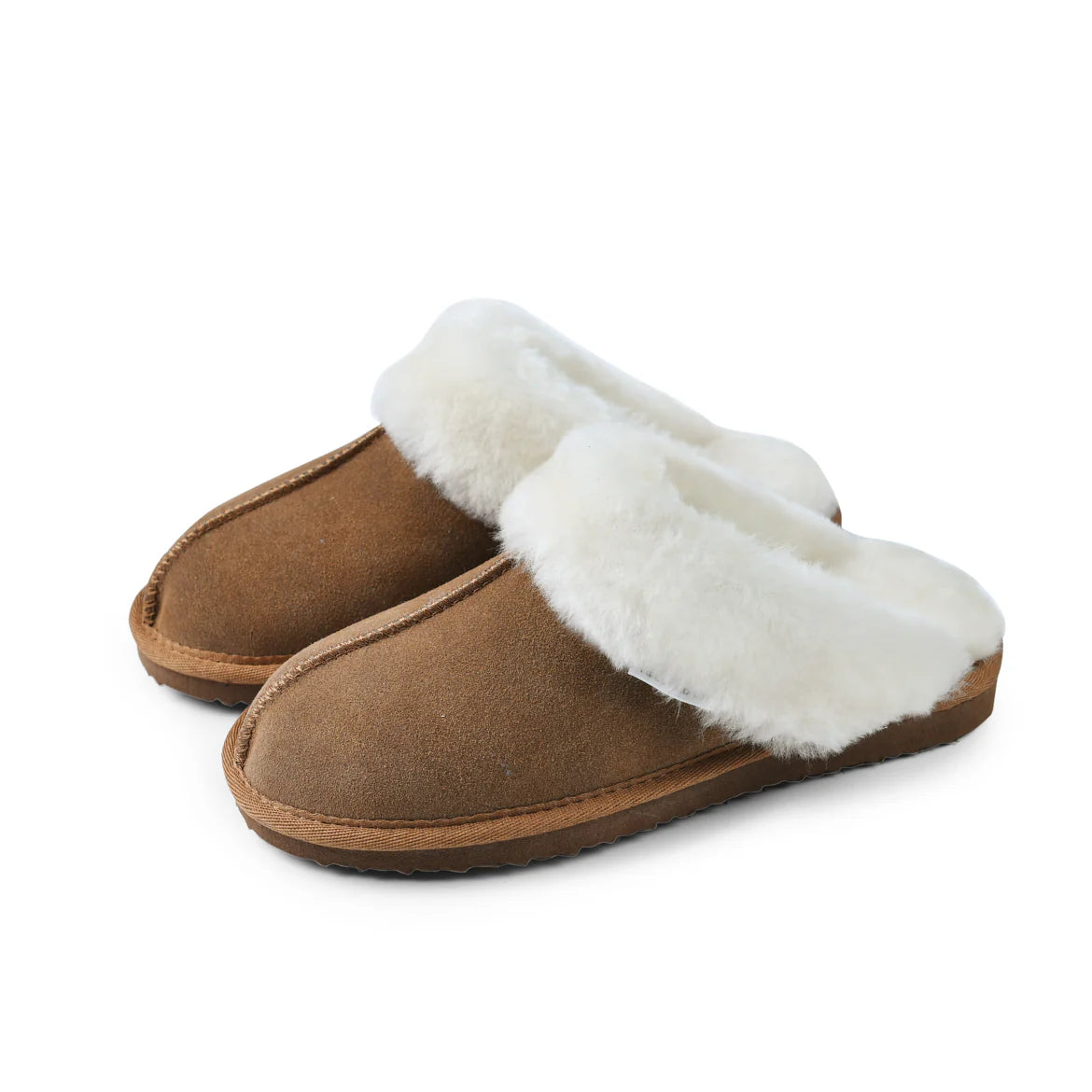 Pair of ladies chestnut sheepskin slippers with fluffy white lining on a plain background.