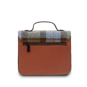 A rear view of a chestnut and blue tartan Harris Tweed satchel bag, showcasing its adjustable strap and additional pocket details.