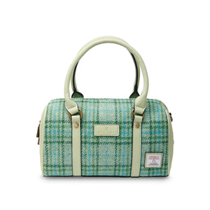 Eye-catching green mint checkered duffel bag crafted from Harris Tweed®, a premium handwoven fabric from the Scottish Outer Hebrides. This stylish bag features double zippers for easy packing, a secure interior pocket, and a detachable shoulder strap for versatile carrying.