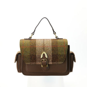 A front view of a chestnut tartan Harris Tweed Melrose Leather Crossbody Bag. It has a front buckle, a side pocket, and a sturdy top handle.