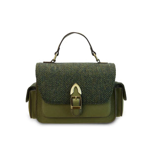 A front view of a green Harris Tweed Melrose Leather Crossbody Bag. It has a front buckle, a side pocket, and a sturdy top handle.