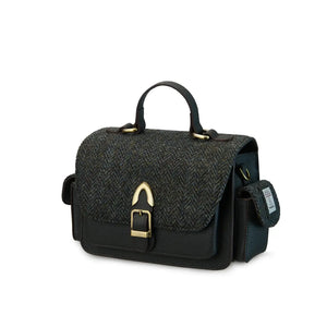 A front view of a black herringbone Harris Tweed Melrose Leather Crossbody Bag. It has a front buckle, a side pocket, and a sturdy top handle.