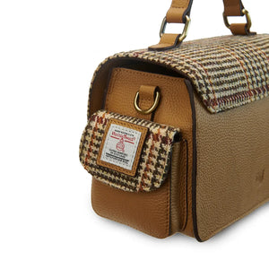 A side view of a beige Harris Tweed Melrose Leather Crossbody Bag. It has a spacious interior and a sturdy top handle.