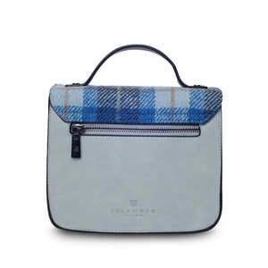 A rear view of a blue tartan Mini Calton Satchel, displaying its additional pocket and metal chain strap.