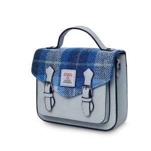 A side view of a stylish blue tartan Mini Calton Satchel, showcasing its compact size and adjustable strap.