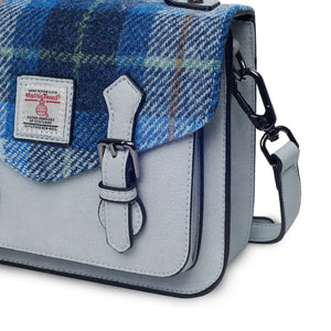 A close-up of the blue tartan Harris Tweed® panel on the Mini Calton Satchel.