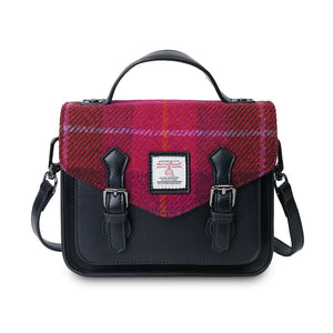 A front view of a red tartan Harris Tweed Mini Calton Satchel with the metal chain strap draped over the bag.