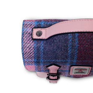 A top-down view of a pink and blue tartan Harris Tweed Mini Calton Satchel, showcasing its rectangular shape and Harris Tweed® panel.