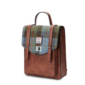 Invest in quality, style, and heritage with the Mini Carloway Backpack, crafted from genuine Harris Tweed®. In Chestnut & Blue Tartan.