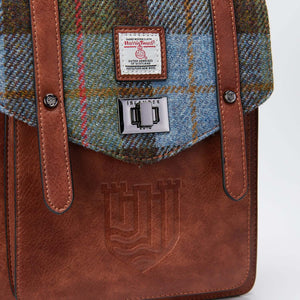 Commute to work in comfort and style with the Mini Carloway Backpack, made from durable Harris Tweed®. In Chestnut & Blue Tartan.