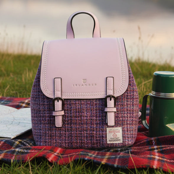 Mini Jura violet backpack on tartan blanket in moorland setting with thermos