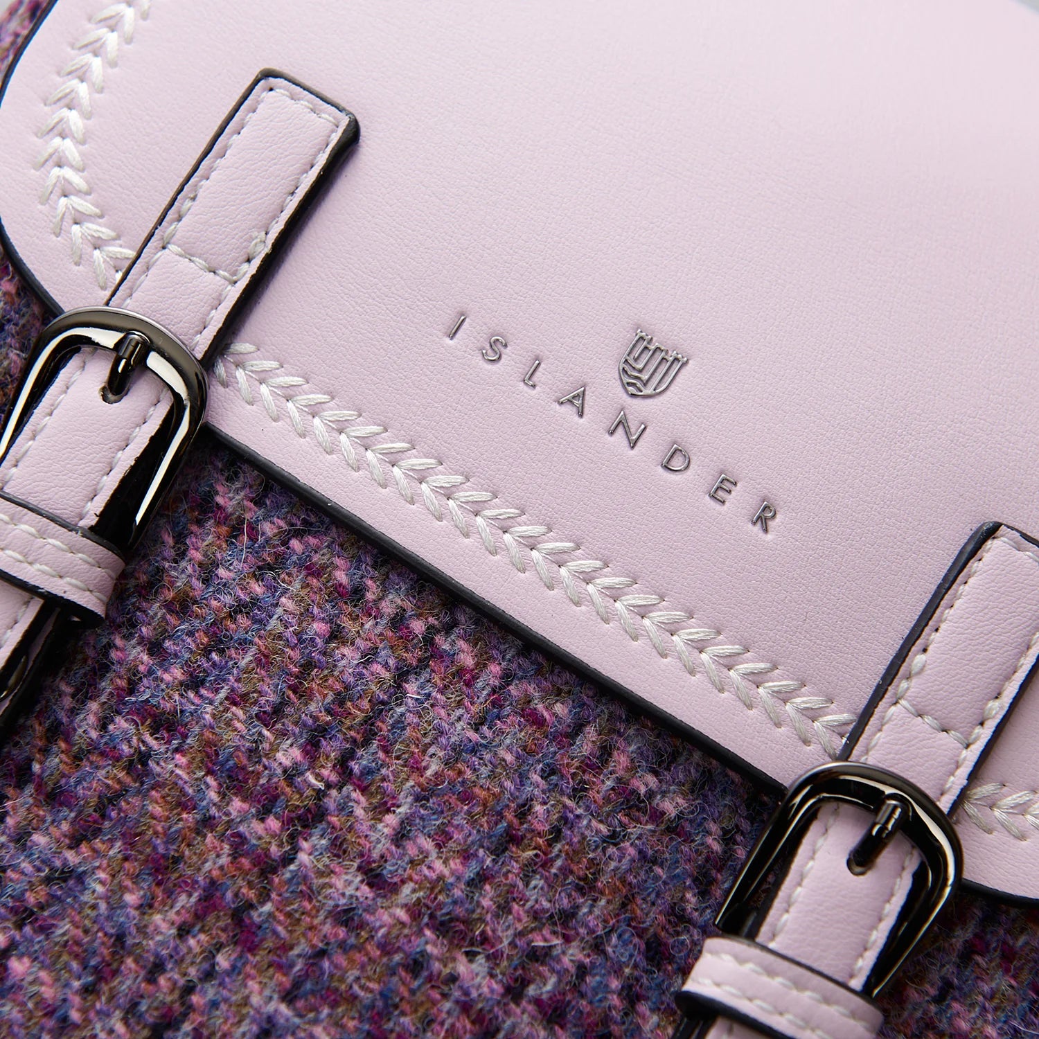 Close-up of buckle straps and Harris Tweed texture on violet backpack