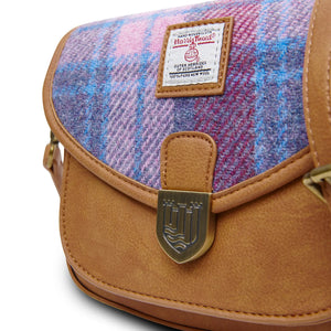 Close up of the magnetic closer of the Mini Saddle Bag. This also shows a closer image of the Pink & Blue Harris Tweed fabric.