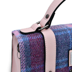 Close up image of the top handle of the Harris Tweed Satchel showing the pink PU leather and tartan pattern.