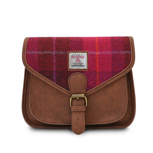 From the front and with the shoulder strap removed the Islander Harris Tweed Saddle Bag in Red tartan.