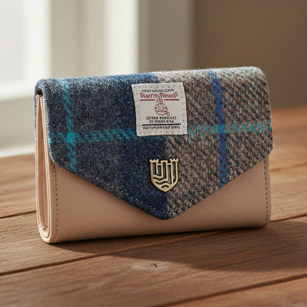 Navy-beige tartan Harris Tweed clasp purse on wooden surface with warm light.