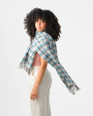 Model wearing Islander tartan lambswool scarf draped across shoulders.