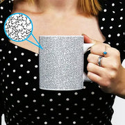Person holding Itty-Bitty-Titty Mug with hidden boob pattern design